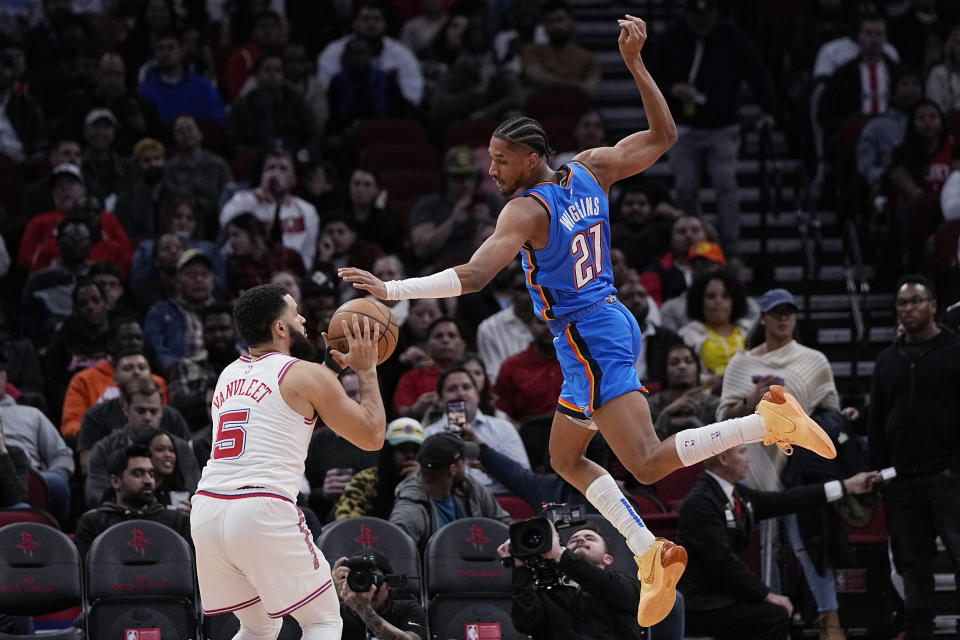 Houston Rockets guard Fred VanVleet (5) is defended by Oklahoma City Thunder guard Aaron Wiggins (21) during the first half of an NBA basketball game Wednesday, Dec. 6, 2023, in Houston. (AP Photo/Kevin M. Cox)