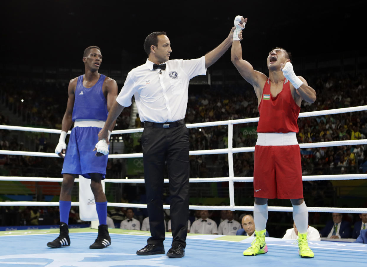 Uzbekistan's Fazliddin Gaibnazarov, right, reacts as he won the gold medal for the men's light welterweight 64-kg boxing against Azerbaijan's Lorenzo Sotomayor Collazo at the 2016 Summer Olympics in Rio de Janeiro, Brazil, Sunday, Aug. 21, 2016. (AP Photo/Frank Franklin II)