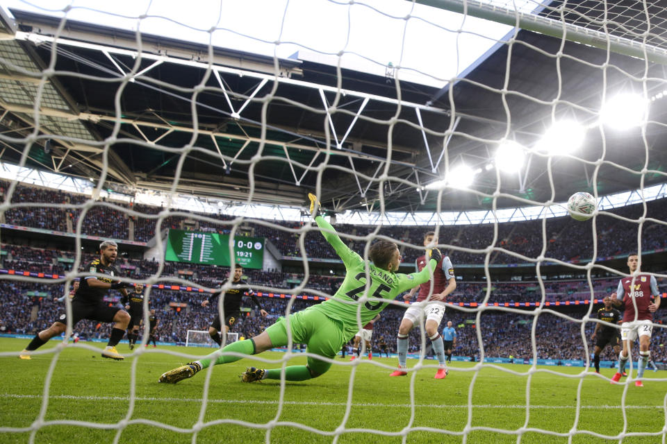 Manchester City's Sergio Aguero, left, scores his side's first goal during the League Cup soccer match final between Aston Villa and Manchester City, at Wembley stadium, in London, England, Sunday, March 1, 2020. (AP Photo/Alastair Grant)