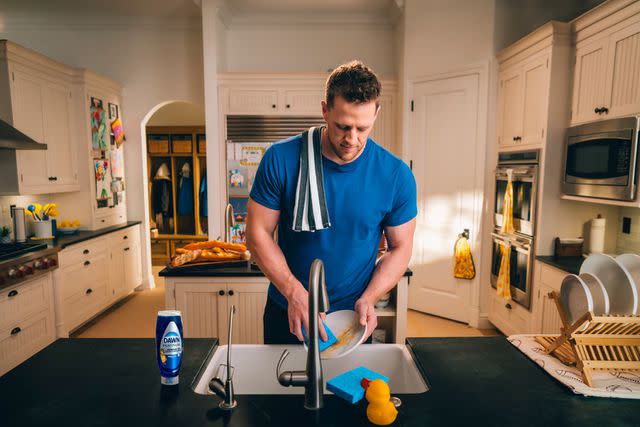 <p>Courtesy of Dawn </p> JJ Watt washing dishes