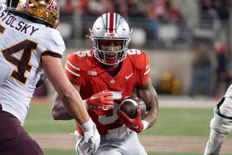 Nov 18, 2023; Columbus, Ohio, USA; 
Ohio State Buckeyes running back Dallan Hayden (5) attempts to run through the Minnesota Golden Gophers defensive line during the second half of their game on Saturday, Nov. 18, 2023 at Ohio Stadium.