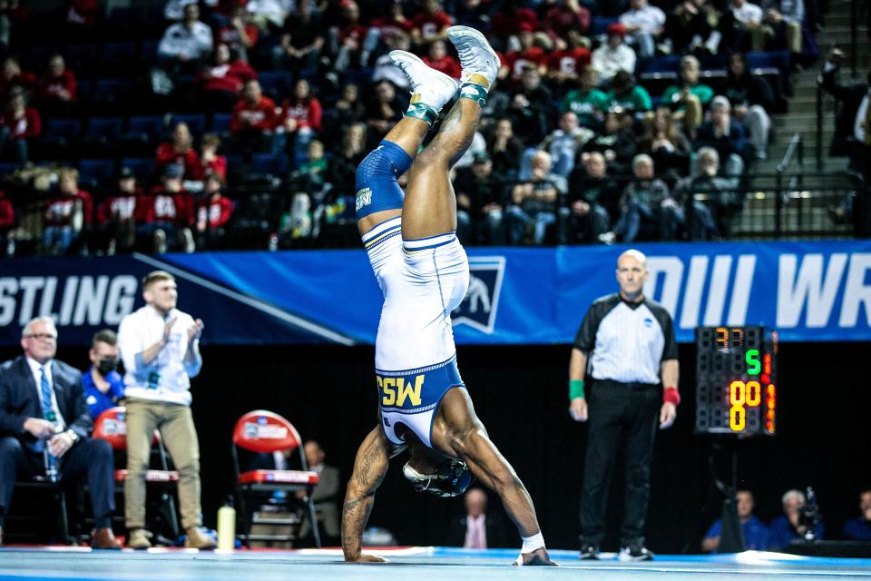 Mount St. Joseph University's Cornell Beachem flips for joy after winning the 174-pounds title at the NCAA DIII Wrestling National Championships, Saturday, March 12, 2022, in Cedar Rapids, Iowa.