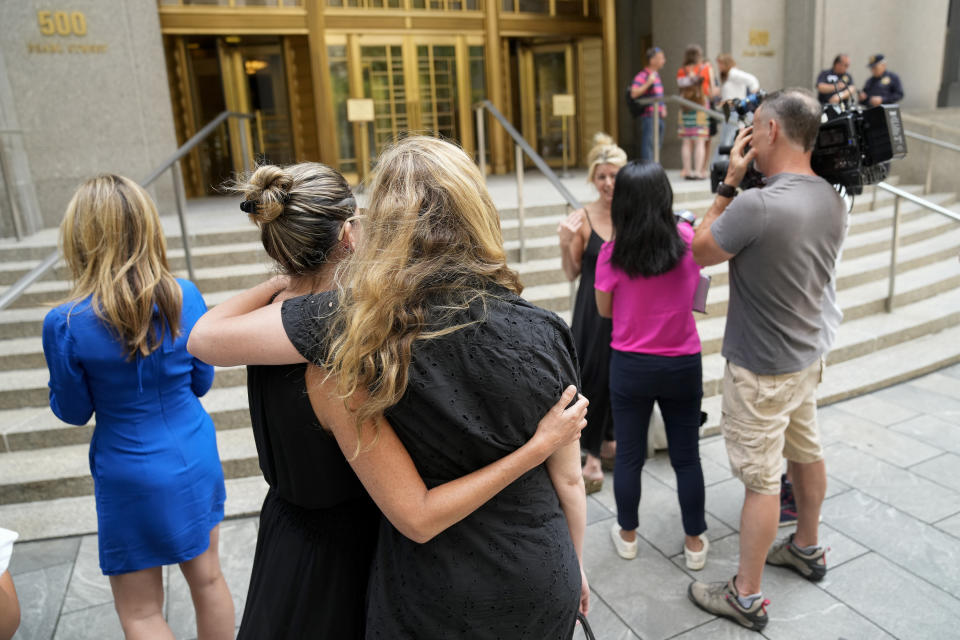 Sexual assault survivor Laurie Kanyok speaks to members of the media as her fellow survivors embrace after sentencing proceedings concluded for convicted sex offender Robert Hadden outside Federal Court, Tuesday, July 25, 2023, in New York. (AP Photo/John Minchillo)