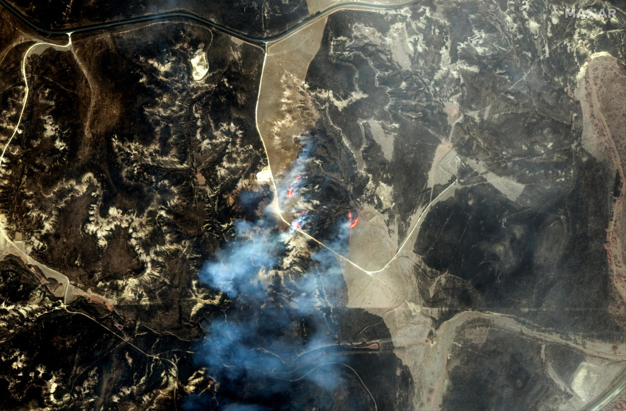 An infrared satellite image shows a fire line and burn scars west of Miami, Texas, Feb. 28, 2024. With color infrared imagery, burned vegetation appears in shades of black and gray. / Credit: Satellite image ©2024 Maxar Technologies