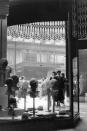 <p>Shoppers flock to a department store located in Midtown Manhattan that boasts display windows filled with trendy hats. </p>