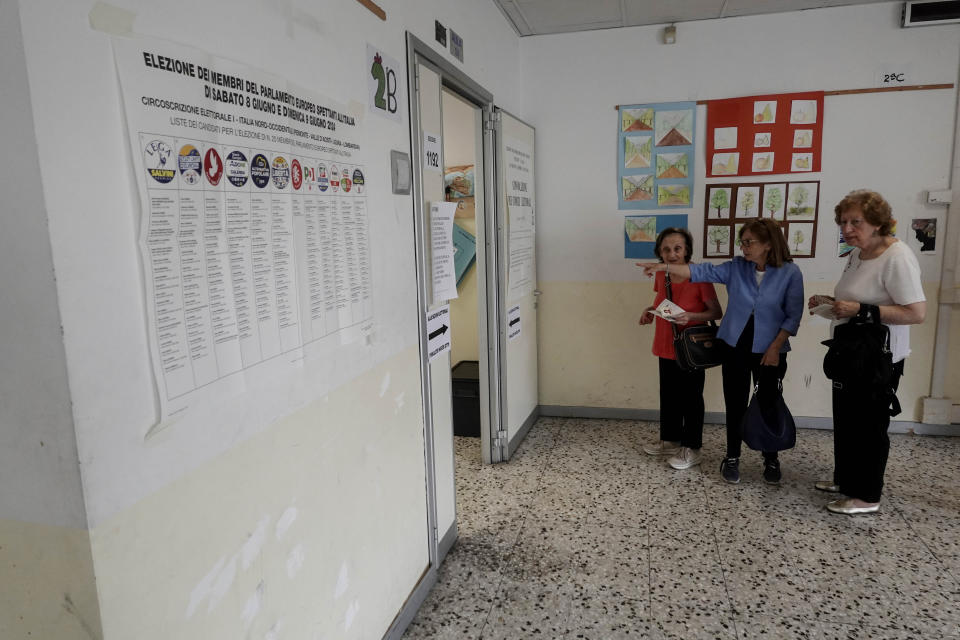 Women talk before entering a polling station in Milan, Italy, Sunday, June 9, 2024. Tens of millions across the European Union were voting in EU parliamentary elections on Sunday in a massive exercise of democracy that is expected to shift the bloc to the right and redirect its future. (AP Photo/Luca Bruno)