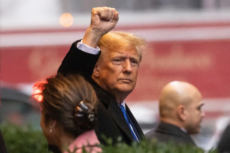 Former President Donald Trump raises his fist as he leaves his apartment building, Thursday, Jan 25, 2024, in New York. (AP Photo/Yuki Iwamura) ORG XMIT: NYYI110