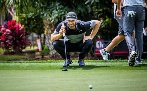 Dustin Johnson lines up a putt - Credit: ap