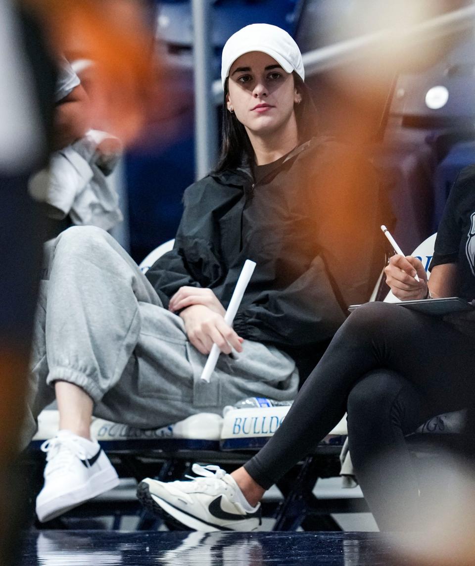 Indiana Fever guard Caitlin Clark (22) watches practice Saturday, Sept. 28, 2024, during a Butler men’s basketball practice at Hinkle Fieldhouse in Indianapolis. As part of Family Weekend at Butler, the men's basketball team opened its practice to fans.