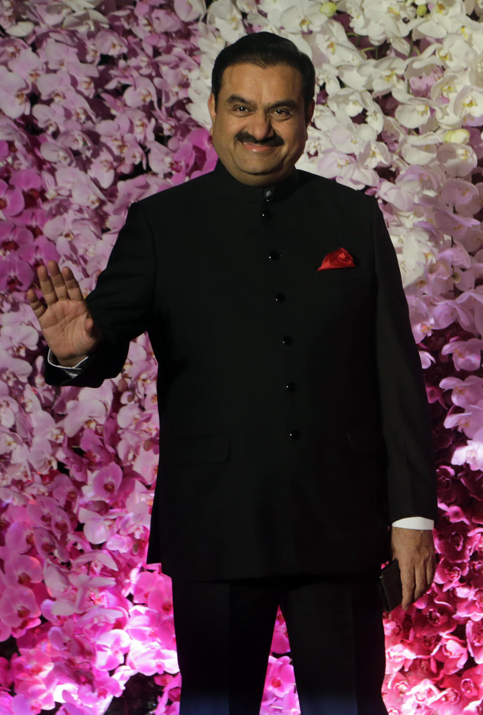 FILE- Adani Group Gautam Chairman Gautam Adani poses during Akash Ambani's wedding reception in Mumbai, India, March 10, 2019. Asia’s richest man, Gautam Adani, made his vast fortune betting on coal as an energy hungry India grew swiftly after liberalizing its economy in the 1990s. He's now set his sights on becoming world's biggest renewable energy player, by 2030, adroitly aligning his investments with the government’s own priorities. (AP Photo/Rajanish Kakade, File)