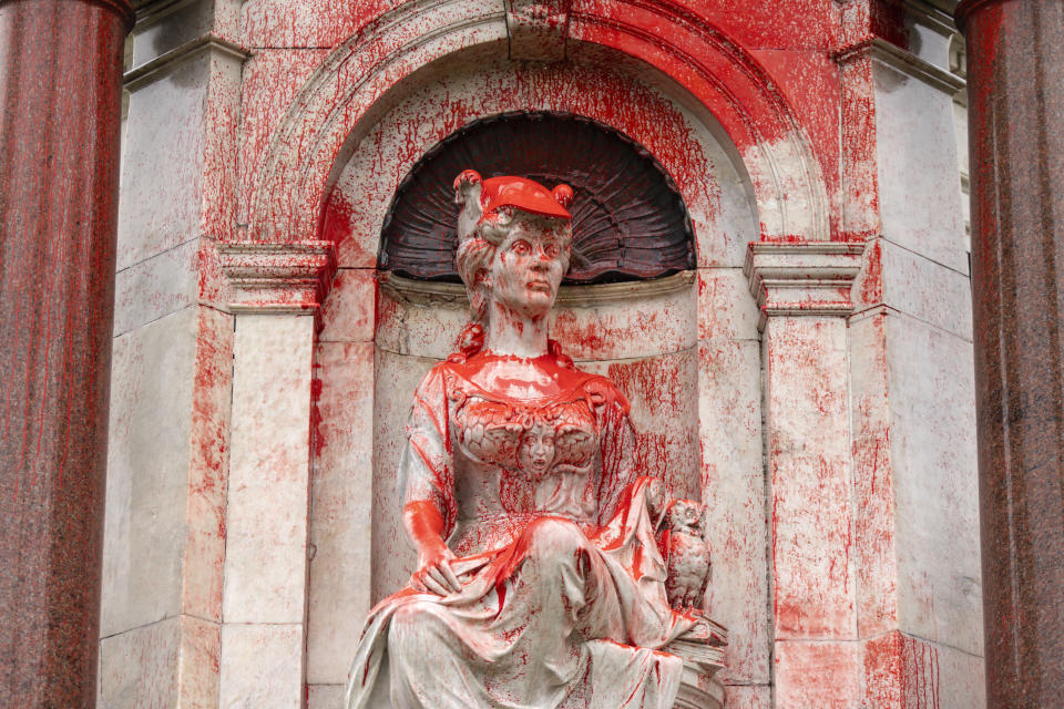 A Queen Victoria monument in Melbourne, Australia, is doused with red paint Thursday, Jan. 25, 2024. Two monuments symbolizing Australia's colonial past were damaged by protesters on Thursday ahead of an increasingly polarizing national holiday that marks the anniversary of British settlement. (Diego Fedele/AAP Image via AP)