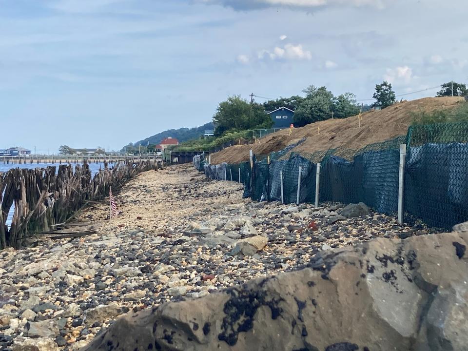 To the right, a black silt fence in front of the Brant Point construction site in Atlantic Highlands. To the left, what's left of the retaining wall in front of Sandy Hook Bay.