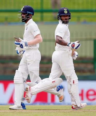 Cricket - Sri Lanka v India - Third Test Match - Pallekele, Sri Lanka - August 12, 2017 - India's Lokesh Rahul and Shikhar Dhawan run between wickets. REUTERS/Dinuka Liyanawatte