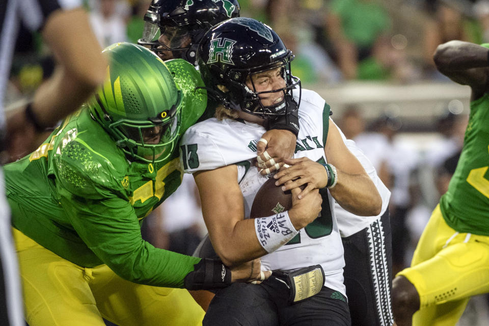 Oregon defensive tackle Popo Aumavae (50) sacks Hawaii quarterback Brayden Schager (13) during the second half of an NCAA college football game Saturday, Sept. 16, 2023, in Eugene, Ore. (AP Photo/Andy Nelson)