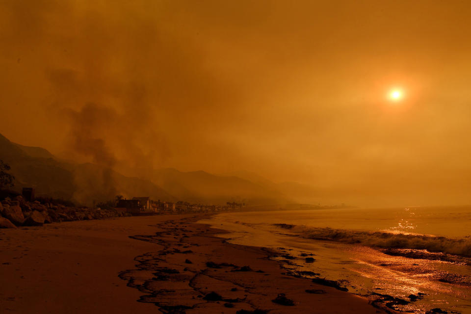 <p>Heavy smoke covers the seaside enclave of Mondos Beach, California, beside the 101 highway as flames reach the coast during the Thomas wildfire on December 6.</p>