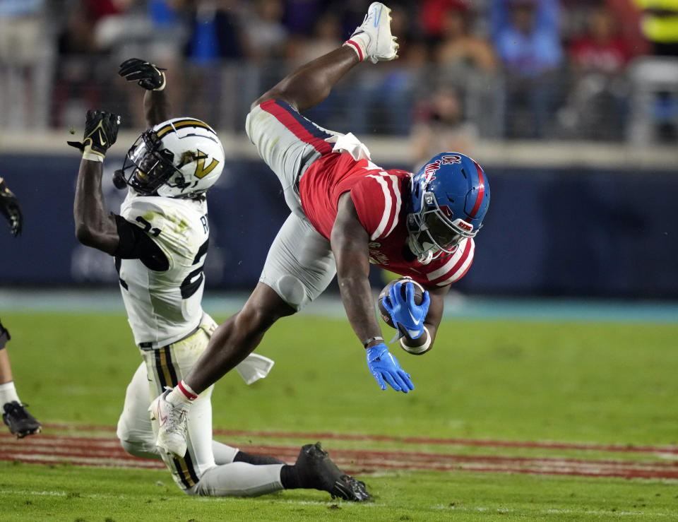 Mississippi running back Quinshon Judkins (4) is tackled by Vanderbilt safety Savion Riley (21) during the first half of an NCAA college football game in Oxford, Miss., Saturday, Oct. 28, 2023. (AP Photo/Rogelio V. Solis)