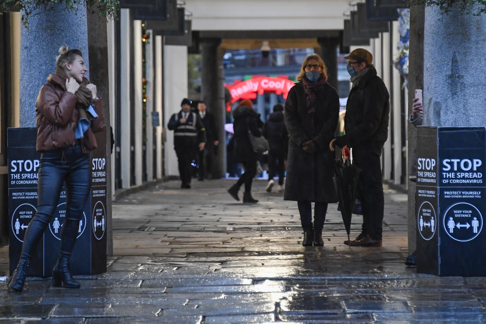 People walking in Covent Garden, London, Thursday, Dec. 3, 2020. Britain became the first country in the world to authorize a rigorously tested COVID-19 vaccine Wednesday and could be dispensing shots within days — a historic step toward eventually ending the outbreak that has killed more than 1.4 million people around the globe. (AP Photo/Alberto Pezzali)