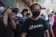 Spokesperson of Hong Kong Alliance in Support of Patriotic Democratic Movements of China Richard Tsoi, right, leaves after the group announced that it's disbanded in Hong Kong, Saturday, Sept. 25, 2021. The Hong Kong group that had organized annual vigils in remembrance of victims of the Chinese military’s crushing of the 1989 Tiananmen Square pro-democracy protests voted to disband Saturday amid an ongoing crackdown on independent political activism in the semi-autonomous Chinese city. (AP Photo/Kin Cheung)