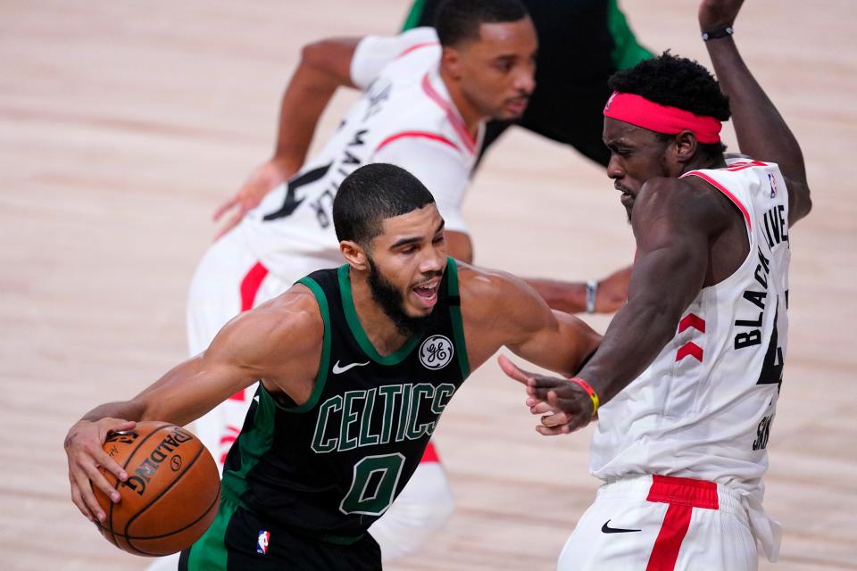 Boston Celtics' Jayson Tatum (0) drives against Toronto Raptors' Pascal Siakam during the second half of an NBA conference semifinal playoff basketball game Friday, Sept. 11, 2020, in Lake Buena Vista, Fla.