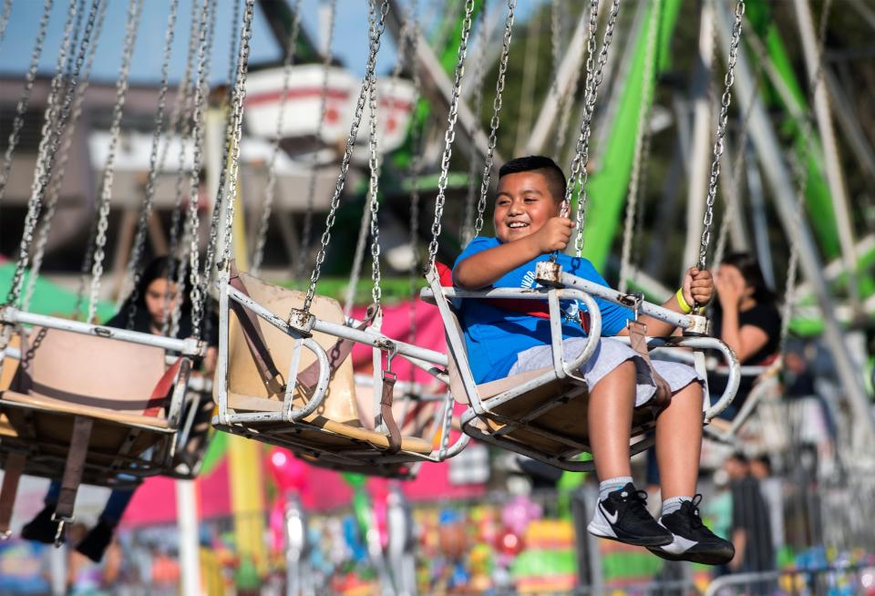 Nine-year-old Abel Tecupa of Stockton rides the Phoenix on June 13, 2019, the opening day of the San Joaquin County Fair at the San Joaquin County Fairgrounds in Stockton.