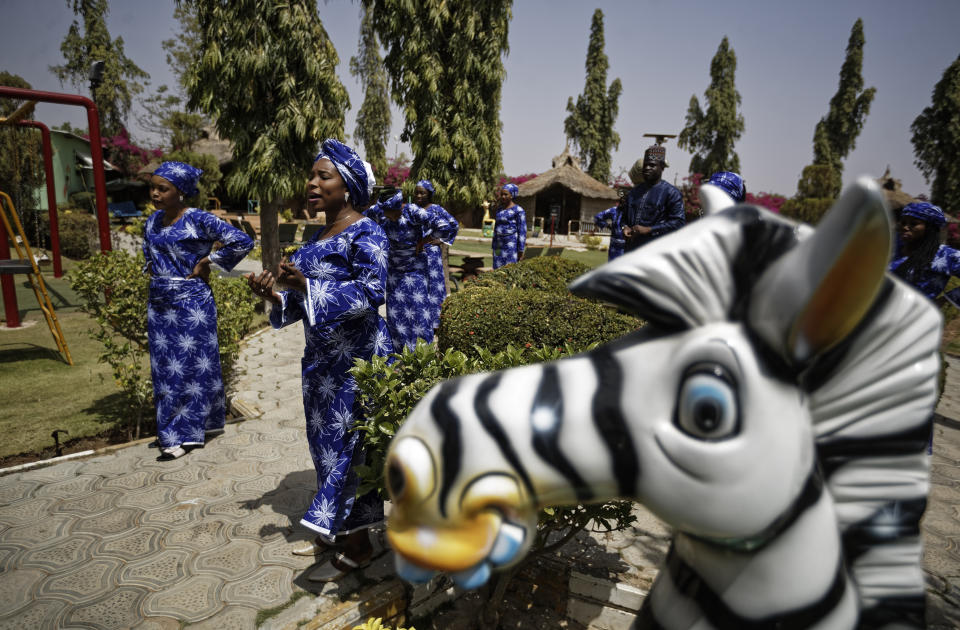 In this photo taken Monday, Feb. 18, 2019, performers record a music video calling for a peaceful election, at a golf resort outside of Kano, northern Nigeria. Faced with an election that could spiral into violence, some in the popular Hausa-language film industry known as Kannywood assembled this week to shoot an urgent music video appealing to the country for peace. (AP Photo/Ben Curtis)