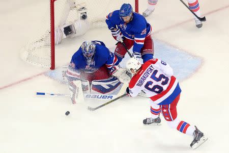 May 8, 2015; New York, NY, USA; New York Rangers goalie Henrik Lundqvist (30) defends against Washington Capitals left wing Andre Burakovsky (65) in front of New York Rangers center Dominic Moore (28) during the second period of game five of the second round of the 2015 Stanley Cup Playoffs at Madison Square Garden. Mandatory Credit: Brad Penner-USA TODAY Sports