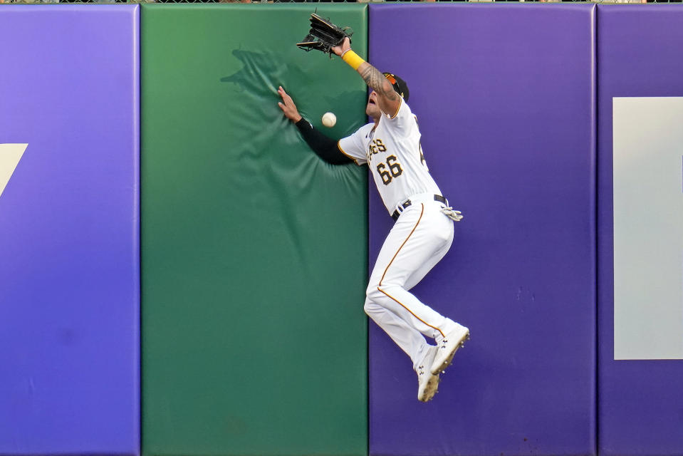 Pittsburgh Pirates right fielder Bligh Madris can't come up with the catch on a two-run triple off the wall hit by Philadelphia Phillies' Darick Hall during the first inning of a baseball game in Pittsburgh, Thursday, July 28, 2022. (AP Photo/Gene J. Puskar)