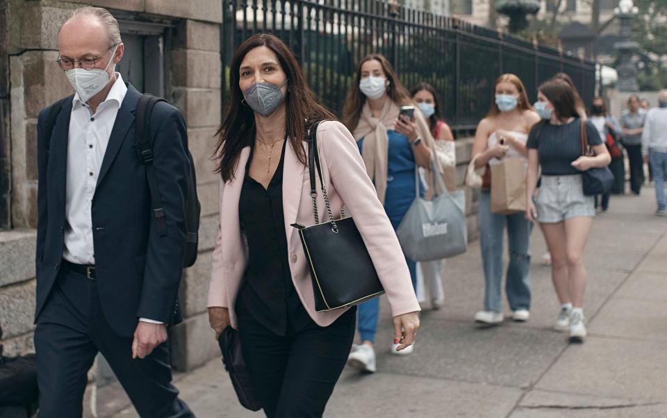 People walk wearing masks as an air quality health advisory was issued in New York - Andres Kudacki/AP