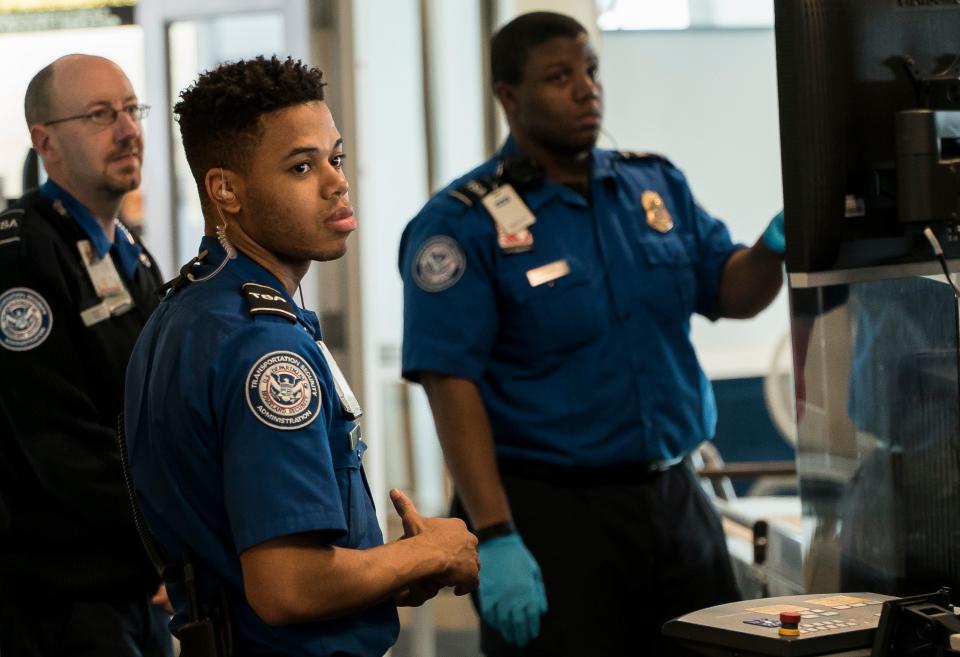 TSA agents at Burlington International Airport in South Burlington, VT, await passengers to screen at a security checkpoint on Friday, Jan. 11, 2019. Despite no paychecks going out, agents continued to report to work, according to airport Federal Security Director Bruce McDonald, but said that agents are working under mounting financial stress.