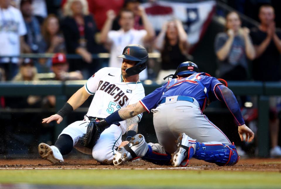 Rangers catcher Jonah Heim tags out Diamondbacks' Christian Walker in the second inning in Game 3.