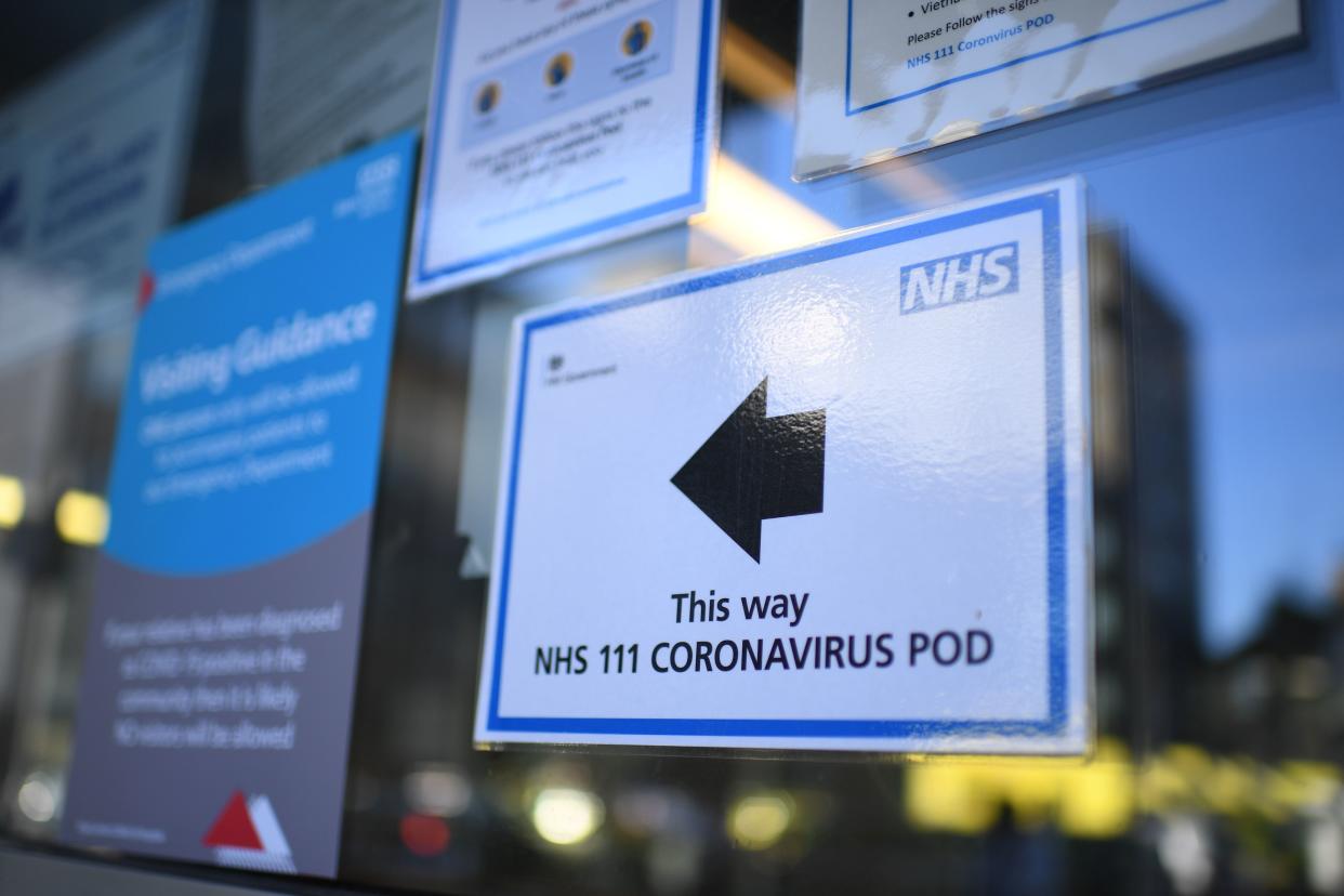 A sign points the way to a NHS 111 Coronavirus Pod at The Royal London Hospital in London on March 23, 2020. - Prime Minister Boris Johnson warned on Sunday he may impose tougher controls on the British public as packed parks, markets and cafes at the weekend showed thousands of people defying government warnings about social distancing. The PM gave notice of potential tougher action as the latest health department figures revealed that 281 people had now died from COVID-19 in the UK, an increase of almost 50 fatalities in the past 24 hours, and there are 5,683 confirmed cases. (Photo by DANIEL LEAL-OLIVAS / AFP) (Photo by DANIEL LEAL-OLIVAS/AFP via Getty Images)