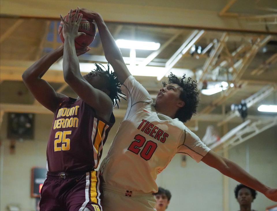 Mount Vernon's BJ Robinson (25) has a shot blocked by Mamaroneck's Cosmo Hardinson (20) during boys basketball at Mamaroneck High School on Tuesday, Jan. 23, 2024. Mamaroneck won 72-61.