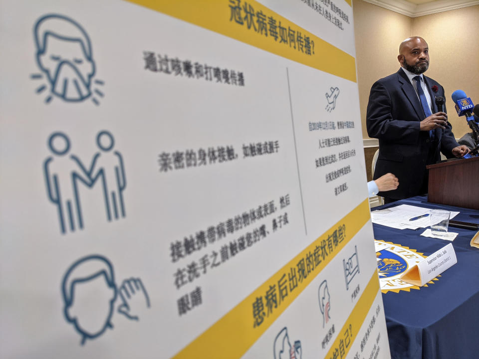 Dr. Muntu Davis, MD, MPH, Los Angeles County Health Office, right, briefs the media on Coronavirus in San Gabriel, Calif., Friday, Jan. 31, 2020, as the outbreak reaches Southern California. (AP Photo/Damian Dovarganes)