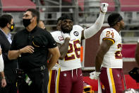 Washington Football Team head coach Ron Rivera and strong safety Landon Collins (26) stand during the national anthem prior to an NFL football game against the Arizona Cardinals, Sunday, Sept. 20, 2020, in Glendale, Ariz. (AP Photo/Ross D. Franklin)