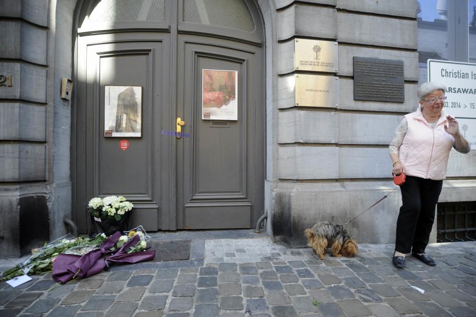 A woman passes in front of the Jewish Museum, the site of a shooting on Saturday, in central Brussels