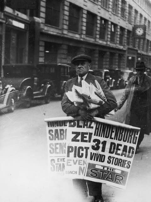 A newspaper seller the day after the Hindenburg disaster - Credit: getty