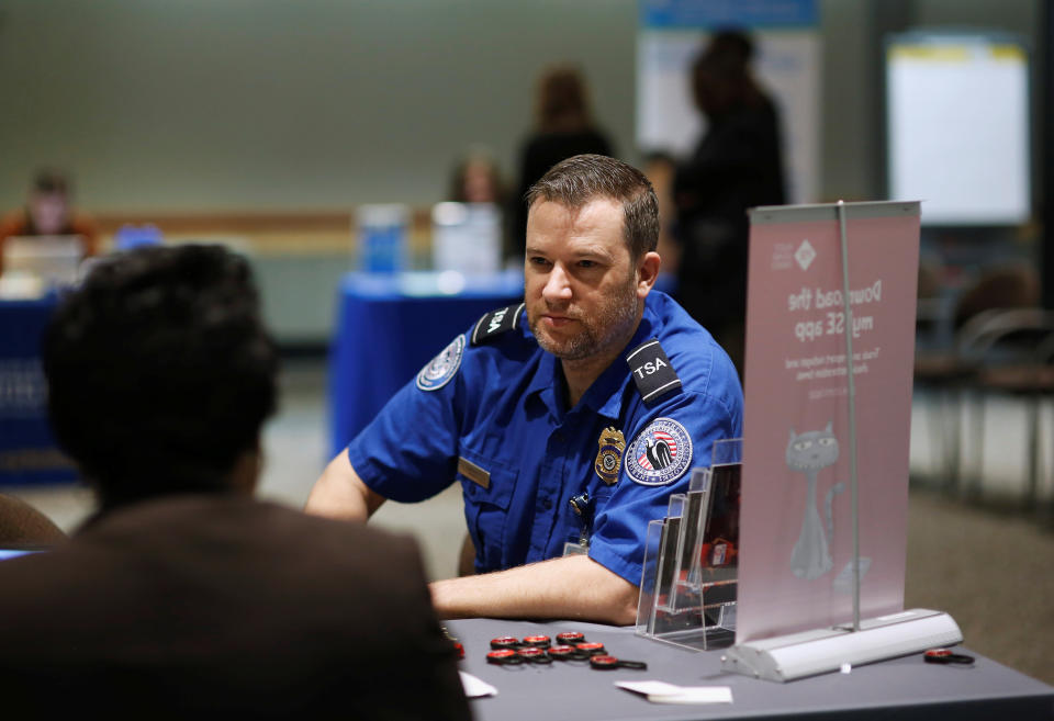 TSA agent Scott Edwards talks with Puget Sound Energy’s Debra Humphrey at a resource fair for employees affected by the partial federal government shutdown at Seattle-Tacoma International Airport on January 14, 2019. The TSA is the most public-facing of the government agencies hit by the shutdown. (Photo: REUTERS/Lindsey Wasson)