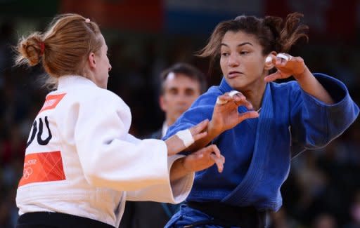 Brazil's Sarah Menezes (right) competes with Romania's Alina Dumitru at the London 2012 Olympics on July 28. Olympic judo champion Menezes revealed Sunday that her parents tried to stop her from taking up the sport which they believed was for men only. The 22-year-old from Brazil became the first woman from her country to win an Olympic judo gold