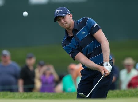 Jun 25, 2017; Cromwell, CT, USA; Daniel Berger chips onto the 1st green during the final round of the Travelers Championship golf tournament at TPC River Highlands. Mandatory Credit: Bill Streicher-USA TODAY Sports