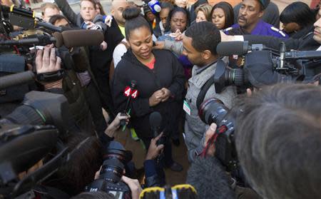 Nailah Winkfield, the mother of Jahi McMath, along with Jahi's uncle Omari Sealy (R), speak with the media outside Children's Hospital and Research Center in Oakland, California, December 30, 2013. REUTERS/Norbert von der Groeben