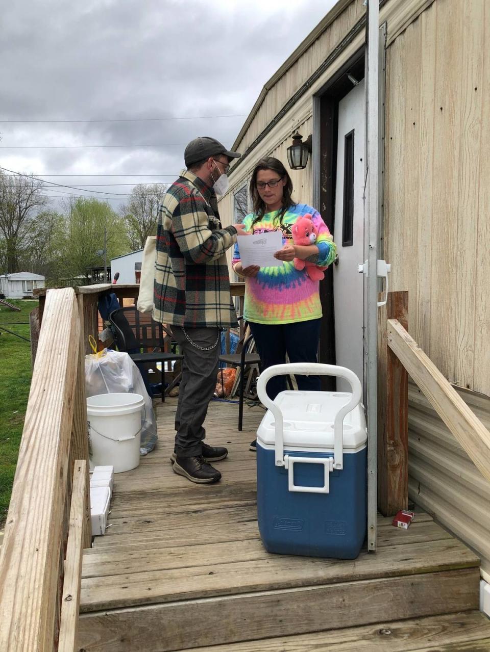 Community supporter Michael Harrington talks to Samantha Massey, a resident of North Fork mobile home park who is being evicted to make way for a new shopping center.