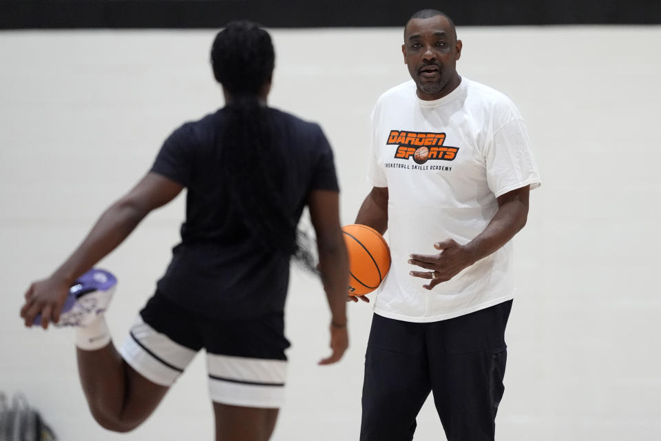 Shay Ijiwoye, who played basketball at Desert Vista High in Phoenix and has committed to Stanford University, works out with coach Tony Darden, Monday, March 18, 2024, in Chandler, Ariz. Iowa’s Caitlin Clark has reshaped women's college basketball and the perception of it. Up-and-coming players have taken notice, working to extend their range to be like her. (AP Photo/Matt York)