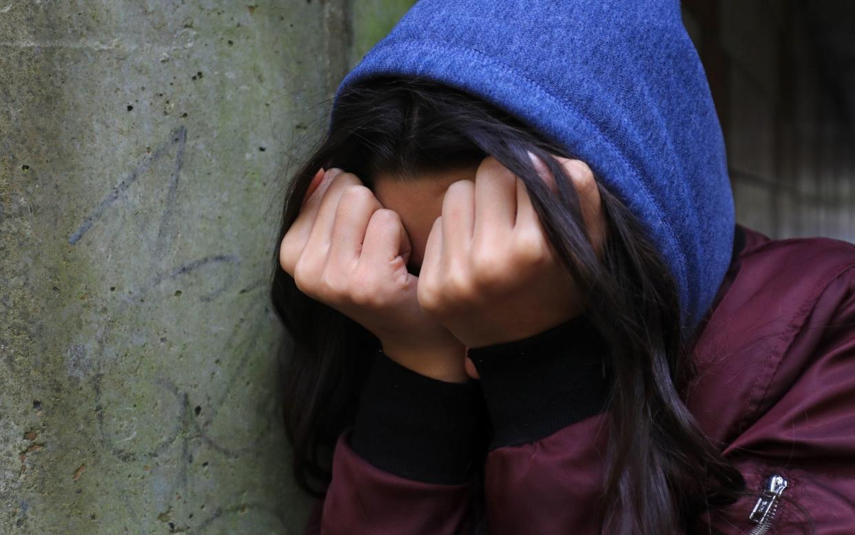A teenage girl with her head in her hands showing signs of mental health problems - Gareth Fuller/PA Wire