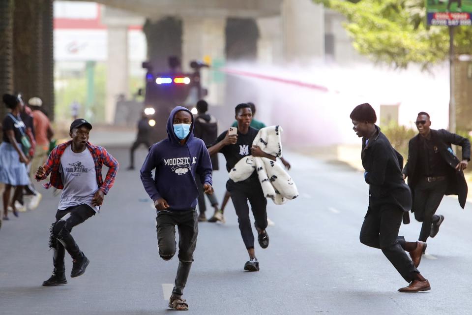 FILE - Protesters run as police use water cannon during a protest in Nairobi, Kenya, Tuesday, July 23, 2024. Police have dispersed small groups of protesters calling for the president’s resignation in Kenya’s capital Nairobi on Thursday, Aug. 8, 2024, as a new Cabinet is sworn in. Protests in Kenya started on June 18 with initial calls for legislators to vote against a controversial finance bill that was proposing increased taxes amidst the high cost of living. (AP Photo/Patrick Ngugi, File)