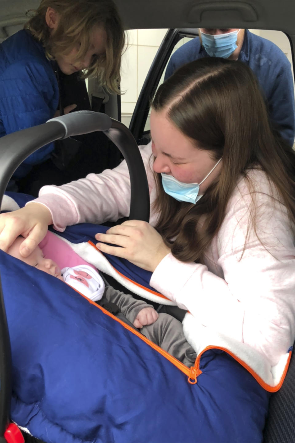 In this March 1, 2021, photo provided by Cortney Haberlau, her daughter Kaylee Gabak, a certified nursing assistant, sees her baby, Charlotte, after leaving Upstate University Hospital in Syracuse, N.Y., months after she nearly died from COVID-19 after giving birth in December. Haberlau, believes her daughter was infected at The Commons on St. Anthony nursing home in mid-December, just before her maternity leave. As the coronavirus made an end-of-the-year surge across New York, few nursing homes escaped unscathed. (Cortney Haberlau via AP)