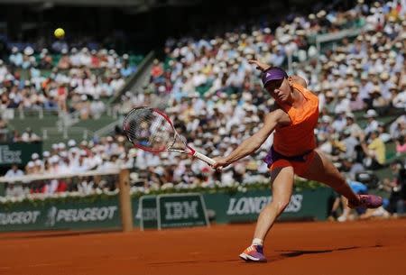 Simona Halep of Romania returns the ball to Maria Sharapova of Russia during their women's singles final match at the French Open tennis tournament at the Roland Garros stadium in Paris June 7, 2014. REUTERS/Stephane Mahe