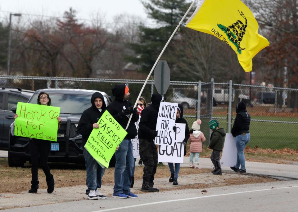 A small group protests Monday afternoon in front of Pilgrim High School in Warwick.