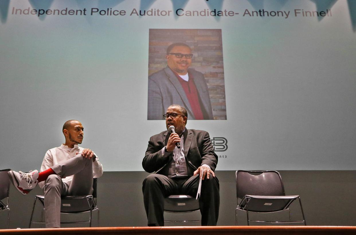 Brandyn Costa, moderator and member of Akron Citizens' Police Oversight Board, listens to Anthony Finnell, the board's pick for the position of police auditor, answer a question during a Feb. 14 town hall hosted by the board at Ellet High School.
