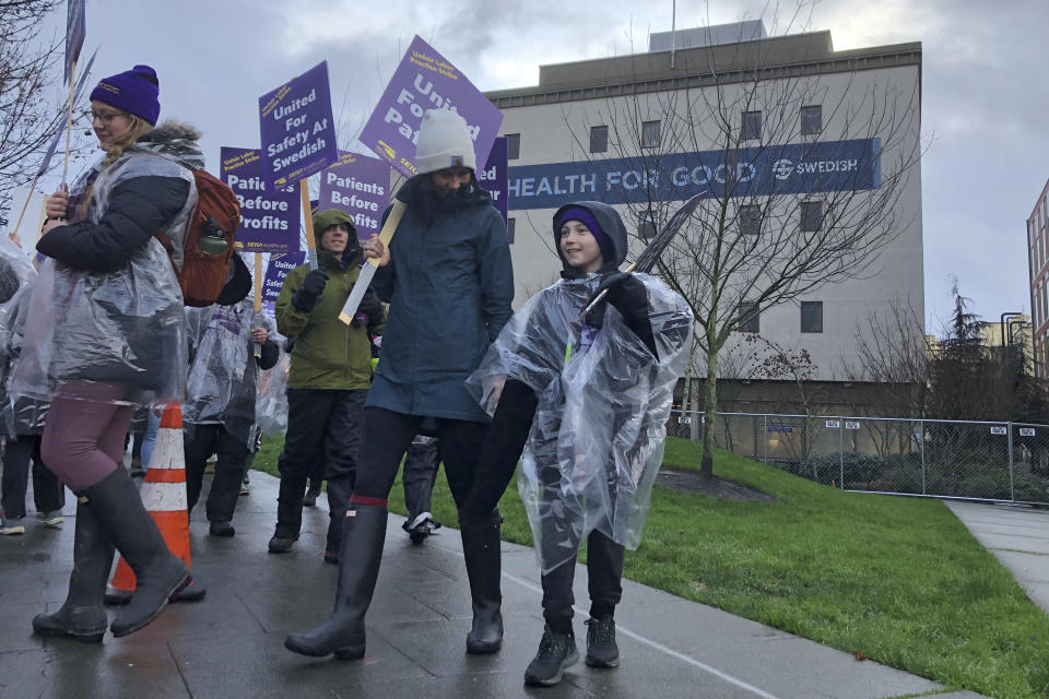 Swedish Medical Center nurses and other workers picket outside the hospital's campus in the Ballard neighborhood of Seattle as they began a three-day strike Tuesday, Jan. 28, 2020, over staffing levels, wages and other issues. The hospital system closed two of its seven emergency departments and brought in replacement workers in response to the strike. (AP Photo/Gene Johnson)