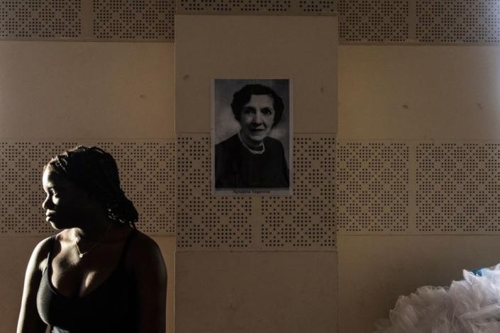 A ballerina stands in front of a portrait of Agrippina Vaganova, a famous soviet and Russian ballet teacher, during a training session for a performance of the Nutcracker in Dakar on November 4, 2022. - Russian ballet dancers Timur Khaiullin and Elena Leonteva are on an internship for a year at the Grande Theatre of Dakar under supervision of Russian ballet master, Slou Akimguereeva. During their internship Khaiullin and Leonteva teach classes to Senegalese ballet dancers. Akimguereeva used to run the Johannesburg Theatre, in South Africa, in the late 90s and she currently runs and directs the Grande Theatre in Dakar where she promotes Russian ballet. They are rehearsing for the Nutcracker that opens on November 25, 2022.